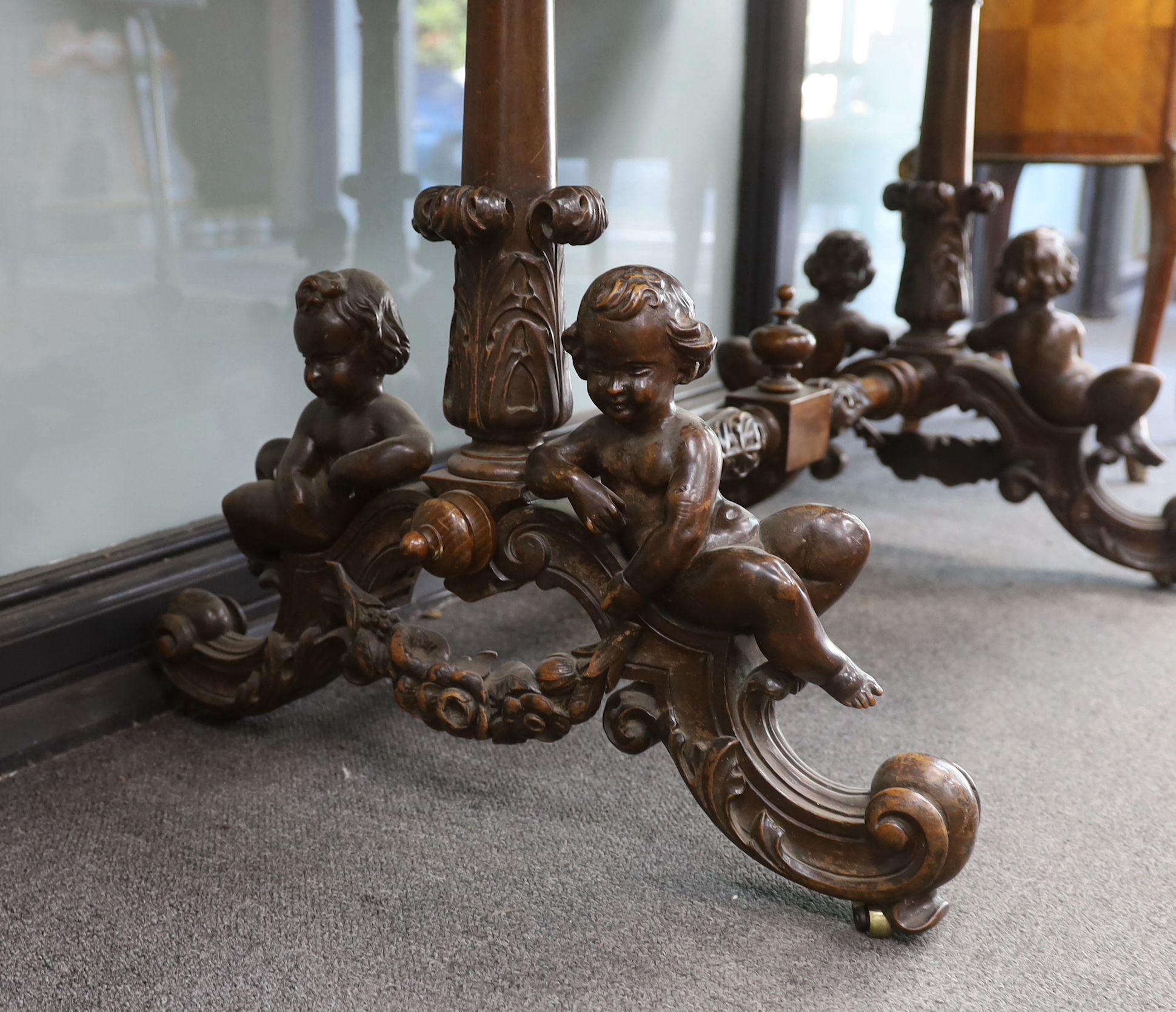 A late 19th century rectangular continental carved walnut centre table with cherub underframe, width 106cm, depth 60cm, height 71cm
